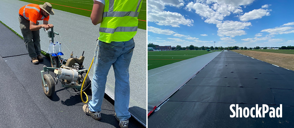 crew installing shock pad beneath artificial grass system